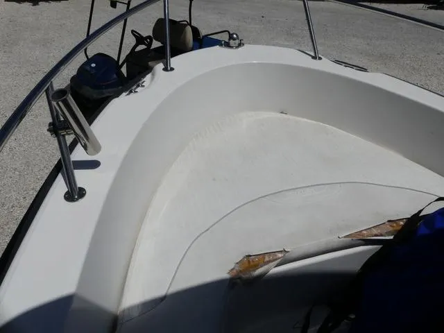 Slide: The Image of 2006 Boston Whaler 190 Outrage boat interior with seating and railing. - 10
