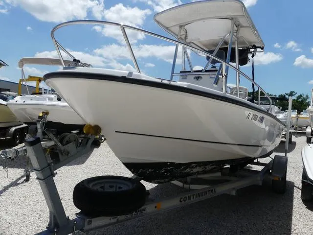 Slide: The Image of 2006 Boston Whaler 190 Outrage boat on trailer under clear blue sky. - 3