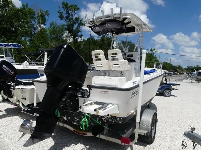 Slide: The Image of 2006 Boston Whaler 190 Outrage boat on trailer, featuring powerful outboard motor. - 4