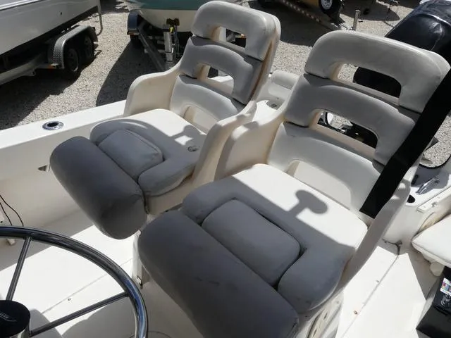 Slide: The Image of 2006 Boston Whaler 190 Outrage boat seats and steering wheel in a sunny outdoor setting. - 8