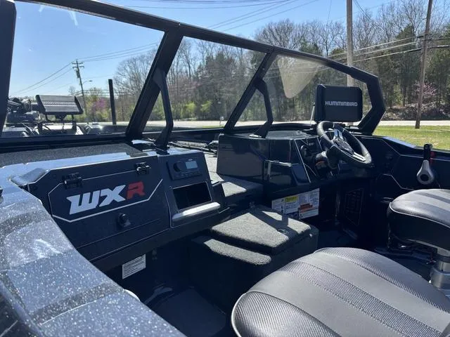 Slide: The Image of 2024 Skeeter WXR2060 F boat interior with steering wheel and dashboard controls. - 11
