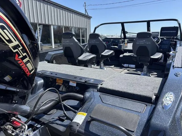 Slide: The Image of 2024 Skeeter WXR2060 F boat interior with seating and controls, featuring a powerful engine. - 3