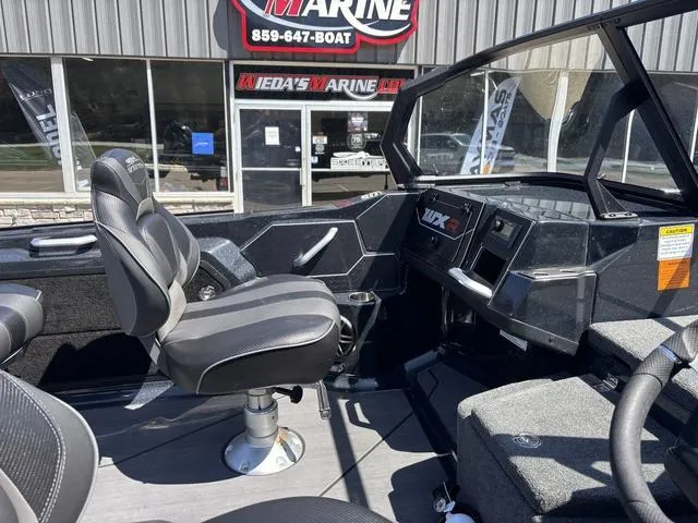 Slide: The Image of 2024 Skeeter WXR2060 F boat interior with seating and control panel. - 5