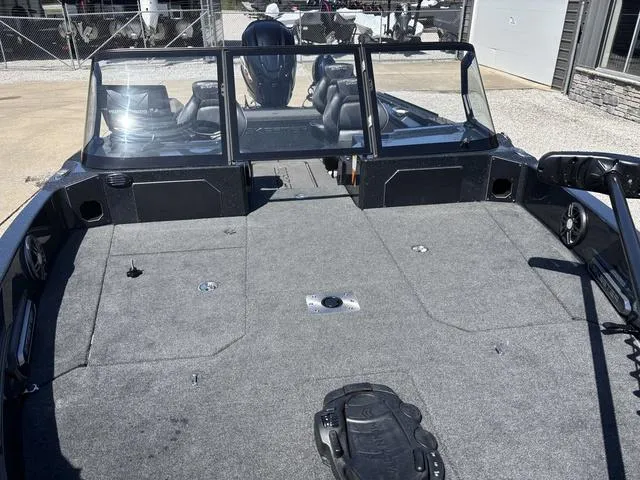 Slide: The Image of 2024 Skeeter WXR2060 F boat with spacious deck and windshield, parked outdoors. - 8