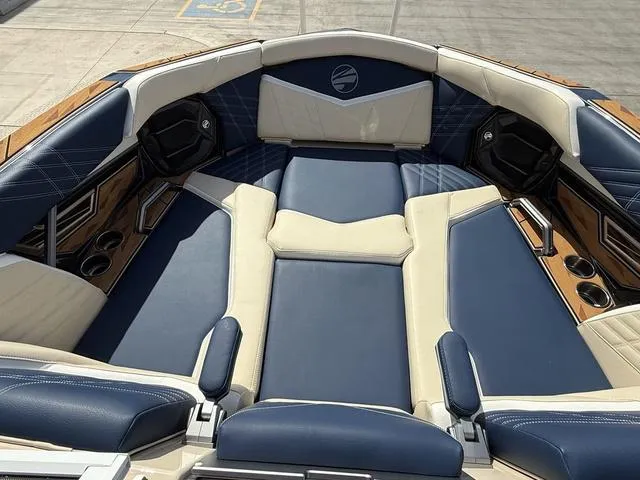 Slide: The Image of 2025 Tigé 23ZX boat interior with luxurious blue and beige seating. - 14