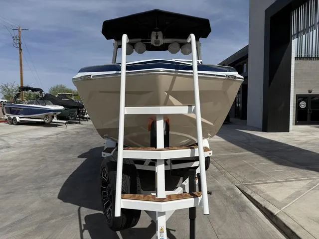Slide: The Image of 2025 Tigé 23ZX boat on trailer, front view, parked outdoors. - 3