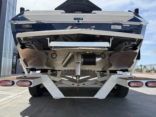 Slide: The Image of 2025 Tigé 23ZX boat on trailer, rear view showing hull and propeller. - 8