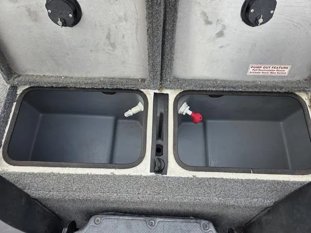 Slide: The Image of Open storage compartments in a 2017 Tracker 195 boat, featuring pump-out feature. - 13