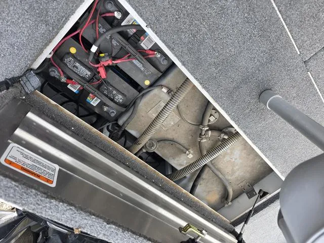 Slide: The Image of Battery compartment of a 2017 Tracker 195 boat, showing wiring and connections. - 14