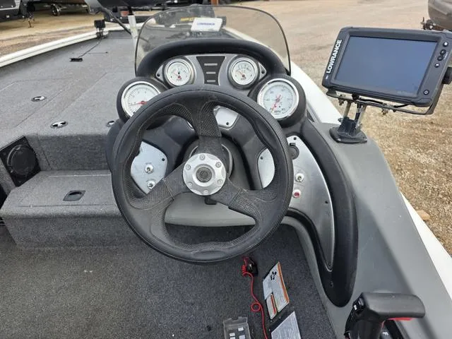 Slide: The Image of Steering wheel and dashboard of a 2017 Tracker 195 boat with navigation system. - 15