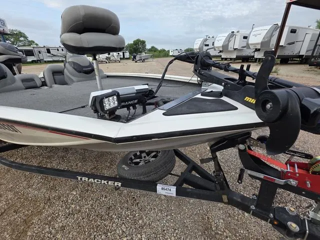 Slide: The Image of 2017 Tracker 195 boat on trailer, equipped with fishing gear, parked in a lot. - 7