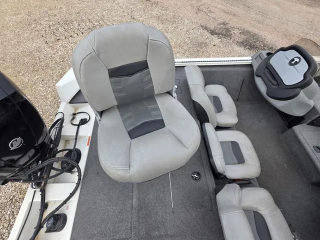 Slide: The Image of 2017 Tracker 195 boat interior with gray seating and motor, showcasing spacious design. - 9