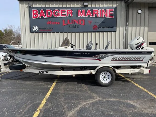 Slide: The Image of 1998 Alumacraft PRO 195 boat on trailer at Badger Marine dealership. - 1