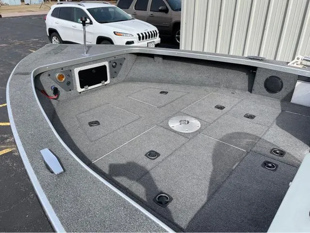 Slide: The Image of 1998 Alumacraft PRO 195 boat interior with carpeted deck and storage compartments. - 11