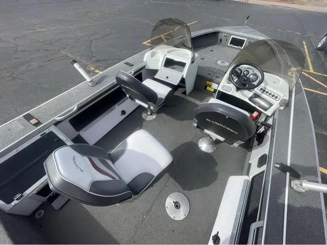 Slide: The Image of 1998 Alumacraft PRO 195 boat interior with two seats and control panel. - 14