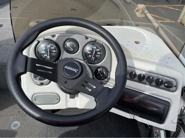 Slide: The Image of 1998 Alumacraft PRO 195 boat dashboard with steering wheel and gauges. - 15