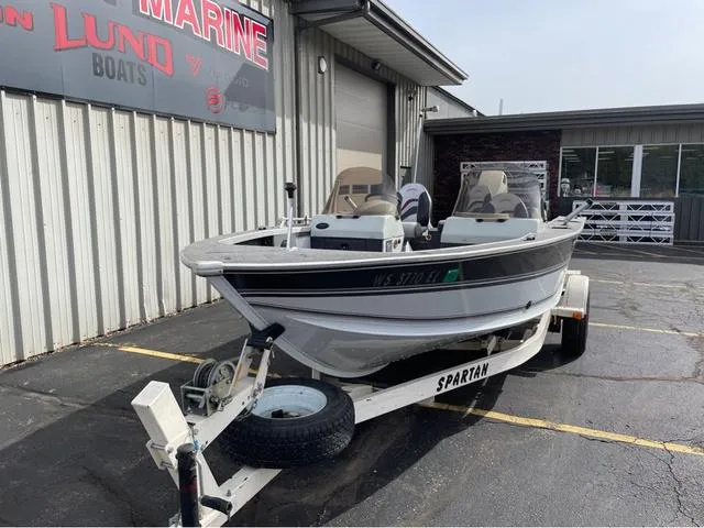 Slide: The Image of 1998 Alumacraft PRO 195 boat on Spartan trailer, parked outside marine shop. - 3