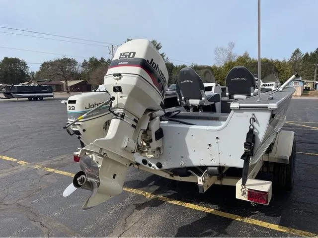Slide: The Image of 1998 Alumacraft PRO 195 boat with Johnson 150 outboard motor in parking lot. - 7