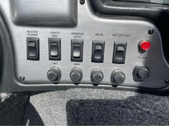 Slide: The Image of Control panel of a 2016 Lund 1650 Rebel XL Sport boat with switches and knobs. - 13