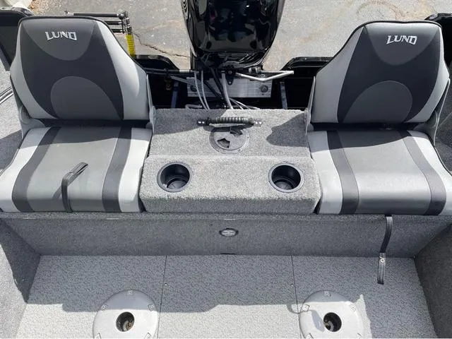 Slide: The Image of 2016 Lund 1650 Rebel XL Sport boat interior with two seats and cup holders. - 15