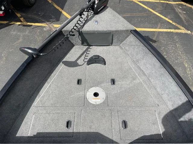 Slide: The Image of 2016 Lund 1650 Rebel XL Sport boat deck with carpeted surface and trolling motor. - 18