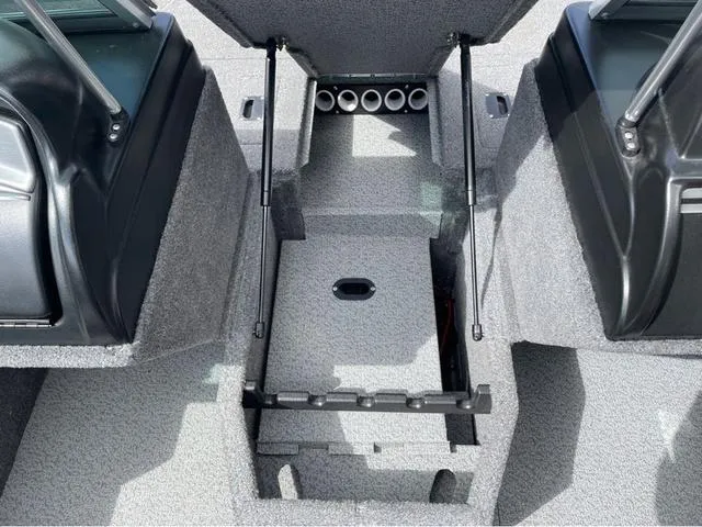 Slide: The Image of 2016 Lund 1650 Rebel XL Sport boat interior with open storage compartment. - 19