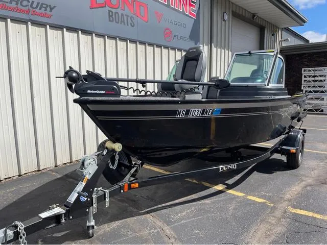 Slide: The Image of 2016 Lund 1650 Rebel XL Sport boat on trailer, parked outside dealership. - 3