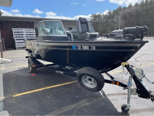 Slide: The Image of 2016 Lund 1650 Rebel XL Sport boat on trailer in parking lot. - 4