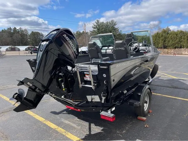 Slide: The Image of 2016 Lund 1650 Rebel XL Sport boat with Mercury engine in parking lot. - 5