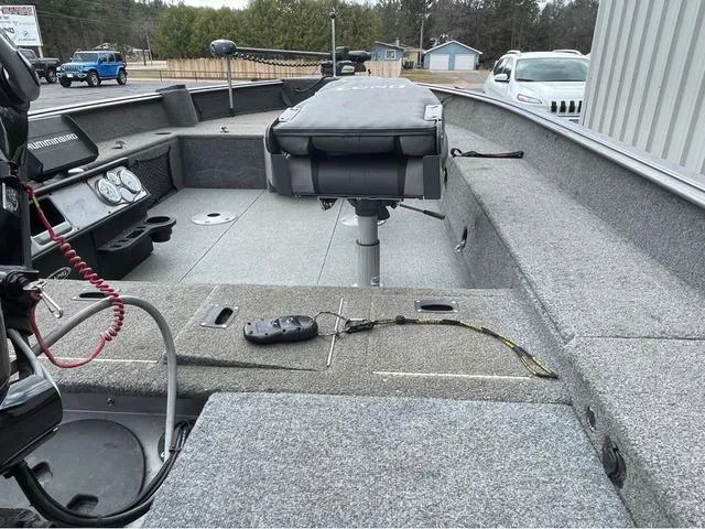 Slide: The Image of 2017 Lund 1675 Pro Guide boat with Mercury engine, spacious interior, and dual seats. - 14