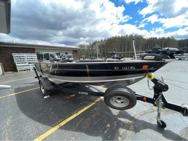 Slide: The Image of 2017 Lund 1675 Pro Guide boat deck with carpeted surface and trolling motor. - 23