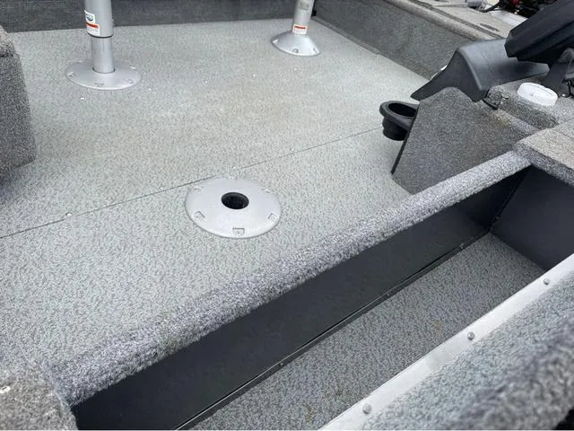 Slide: The Image of 2017 Lund 1675 Pro Guide boat interior with gray carpet and seating mounts. - 31