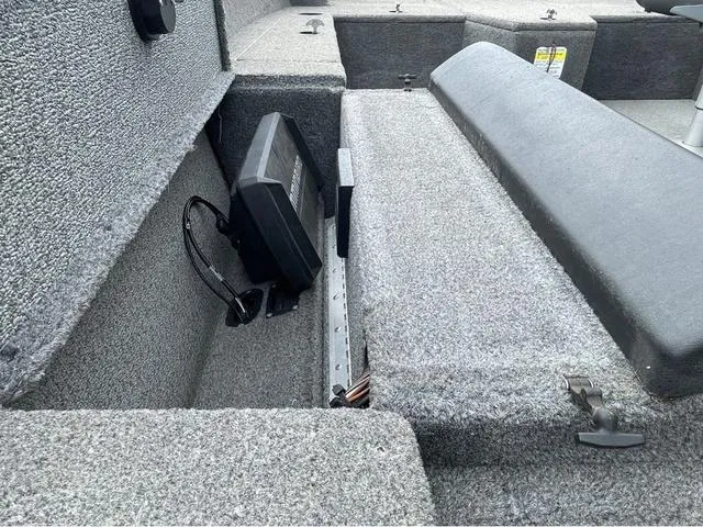 Slide: The Image of 2017 Lund 1675 Pro Guide boat interior with storage compartment and electronic device. - 35