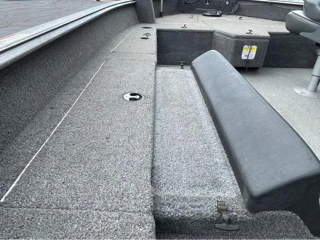 Slide: The Image of 2017 Lund 1675 Pro Guide boat interior with gray carpet and seating. - 36