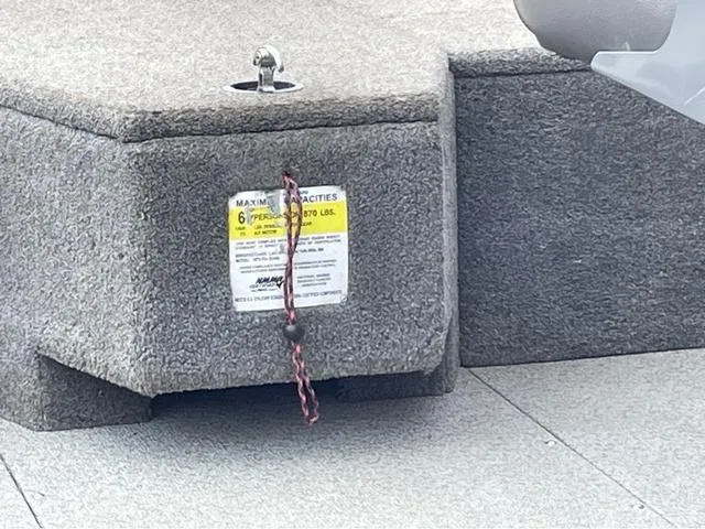 Slide: The Image of 2017 Lund 1675 Pro Guide boat interior with capacity label and safety rope. - 38