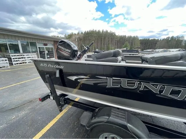 Slide: The Image of 2017 Lund 1675 Pro Guide boat on trailer at Badger Marine dealership. - 4