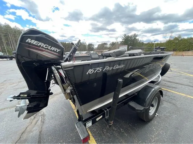 Slide: The Image of 2017 Lund 1675 Pro Guide boat on trailer, parked outside dealership. - 5