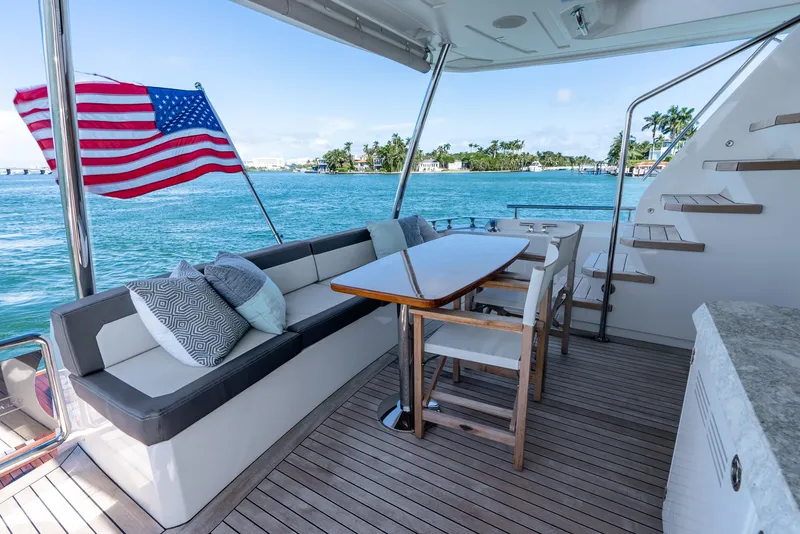 Slide: The Image of Luxurious 2021 Ocean Alexander 70E Motoryacht deck with seating, table, and ocean view. - 18
