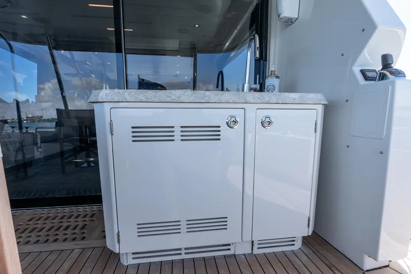 Slide: The Image of 2021 Ocean Alexander 70E Motoryacht outdoor kitchenette with sleek cabinetry and marble countertop. - 19
