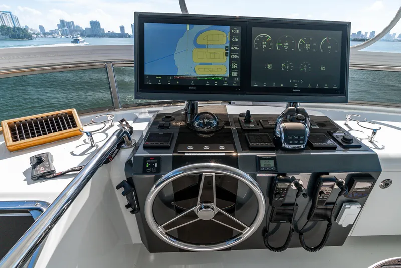 Slide: The Image of Helm of 2021 Ocean Alexander 70E Motoryacht with navigation screens and controls. - 28