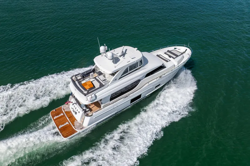 Slide: The Image of 2021 Ocean Alexander 70E Motoryacht cruising on open water, aerial view. - 3