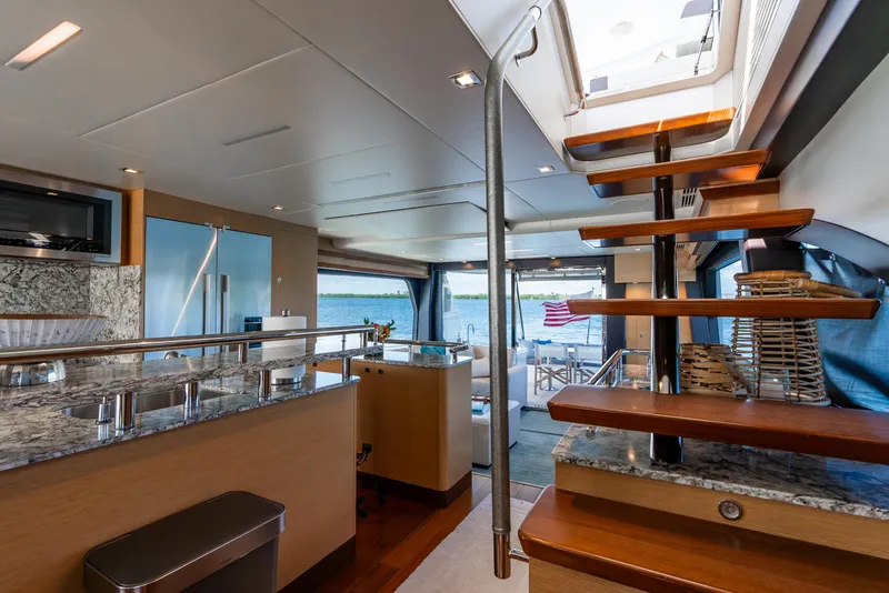 Slide: The Image of Luxurious interior of 2021 Ocean Alexander 70E Motoryacht with modern kitchen and wooden staircase. - 39