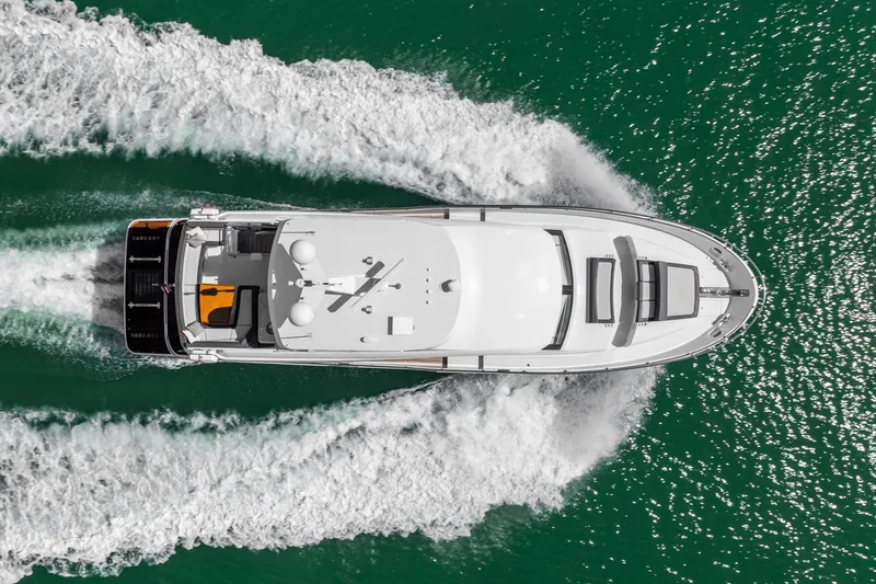 Slide: The Image of Aerial view of 2021 Ocean Alexander 70E Motoryacht cruising on vibrant green water. - 4