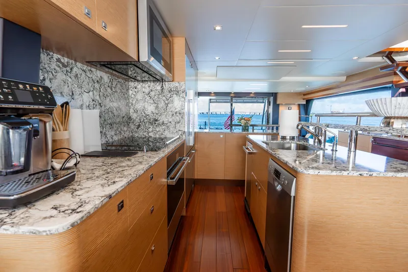 Slide: The Image of Luxurious kitchen interior of 2021 Ocean Alexander 70E Motoryacht with modern appliances and marble countertops. - 41