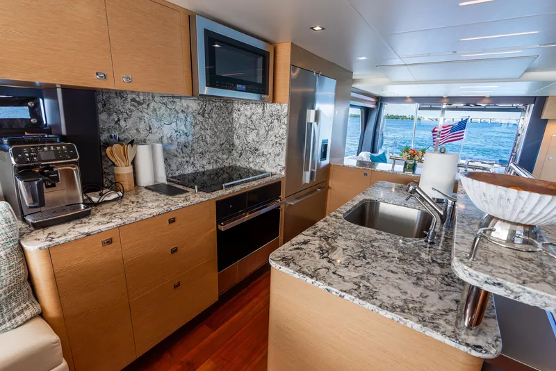 Slide: The Image of Luxurious kitchen interior of 2021 Ocean Alexander 70E Motoryacht with modern appliances and granite countertops. - 42