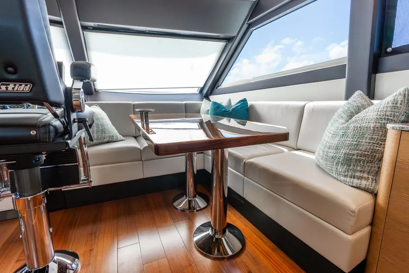 Slide: The Image of Luxurious interior of 2021 Ocean Alexander 70E Motoryacht with plush seating and elegant table. - 44