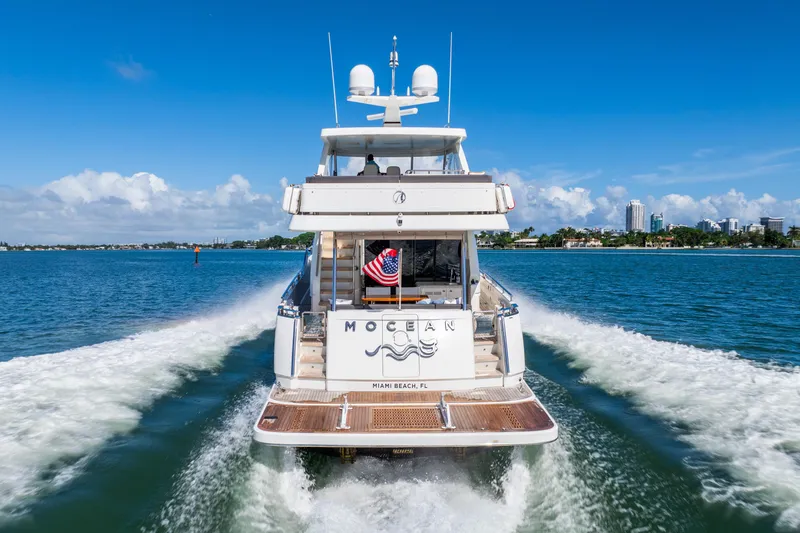 Slide: The Image of 2021 Ocean Alexander 70E Motoryacht cruising on open water, rear view. - 8
