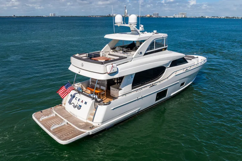 Slide: The Image of 2021 Ocean Alexander 70E Motoryacht cruising on open water, rear view. - 9