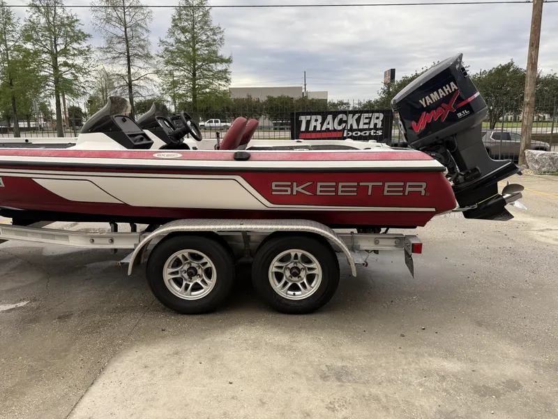 Slide: The Image of 2005 Skeeter SX 200 boat on trailer with Yamaha VMAX engine, parked outdoors. - 4