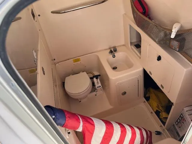 Slide: The Image of 2003 Grady-White 306 CC boat interior with toilet and sink. - 10